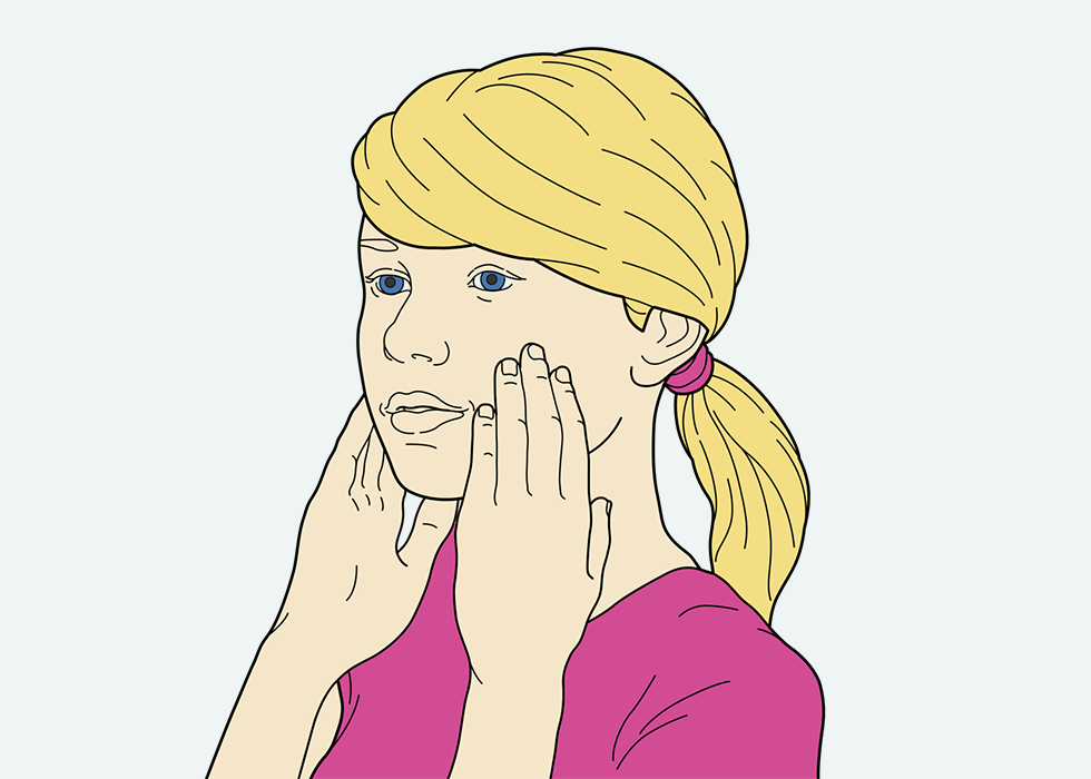 A person touching their face with their hands.