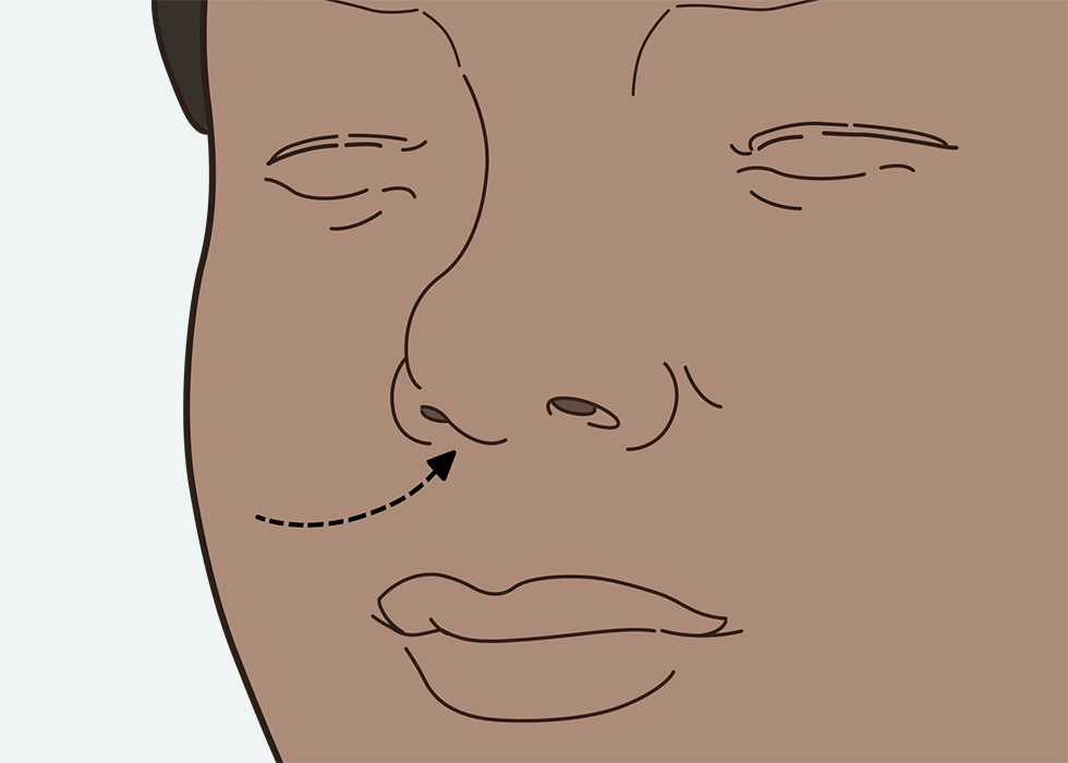 Person breathing in through their nose.