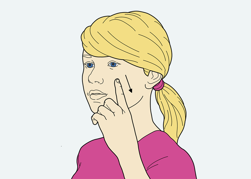 Person stroking their cheek with one finger.