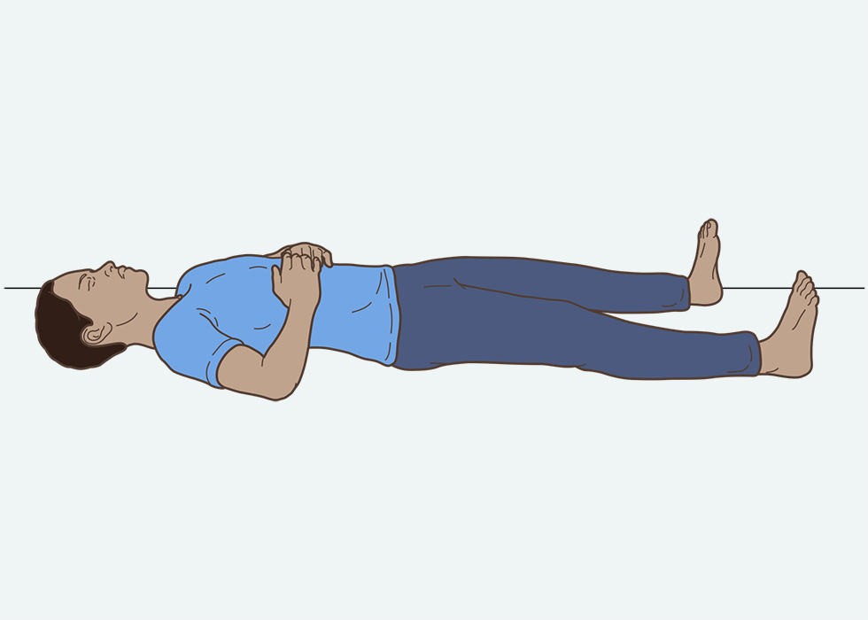 Person lying on their back with their hands just below their ribs.