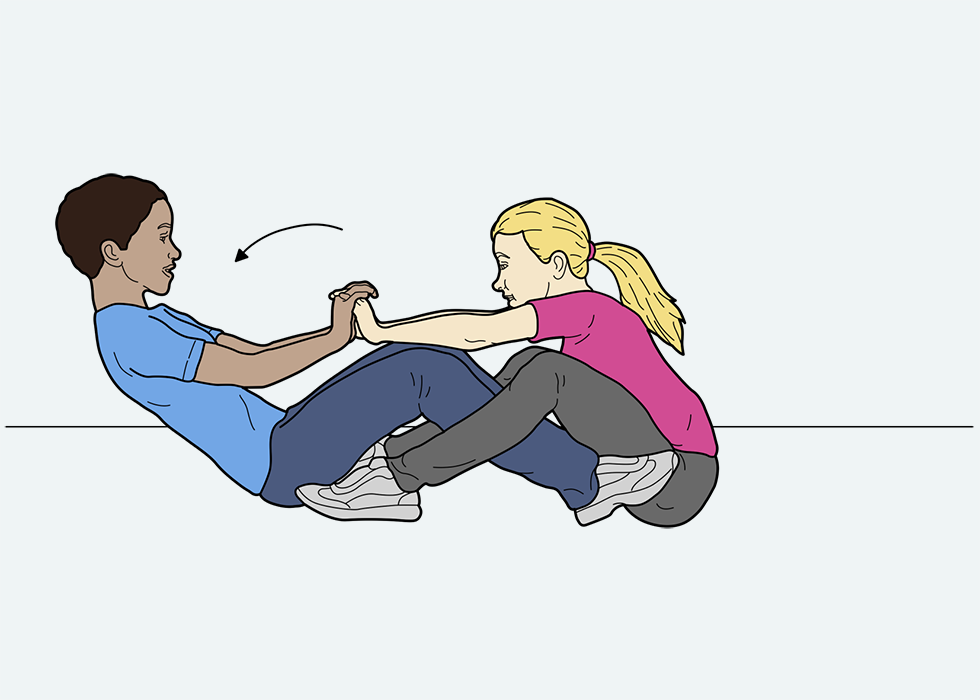 Two people sitting on the ground facing each other demonstrating 'row your boat'.
