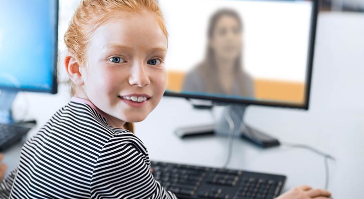 Image of person sitting in front of a computer
